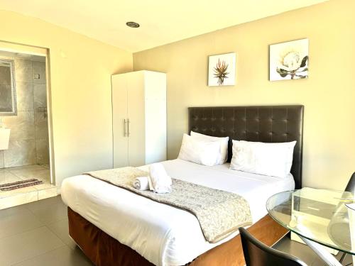 a bedroom with a bed and a glass table at Angel Boutique Hotel in Maputo