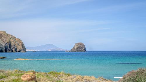 a view of the ocean with mountains in the background at Nove Milos Luxury by Estia in Pollonia