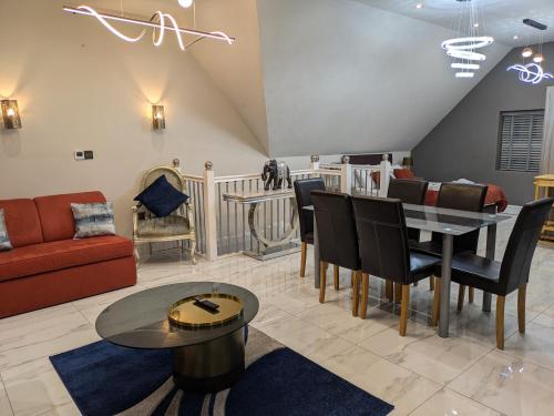 a living room with a couch and a table at Village Life, Beautiful Studio Apartment in Wombourn