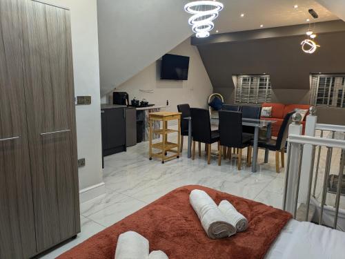 a living room with a bed and a dining room at Village Life, Beautiful Studio Apartment in Wombourn