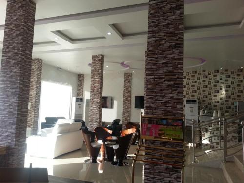 a living room with a brick fireplace and chairs at Lara Al Jawf Hotel Apartments in Sakakah