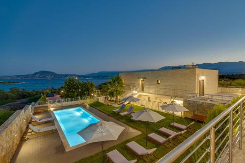 a villa with a swimming pool and a balcony at Elios Estate for large groups in Chania Town