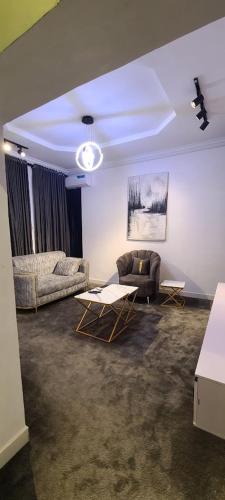 a living room with a couch and a table at Comfortable 1 bedroom Apartment in Garki