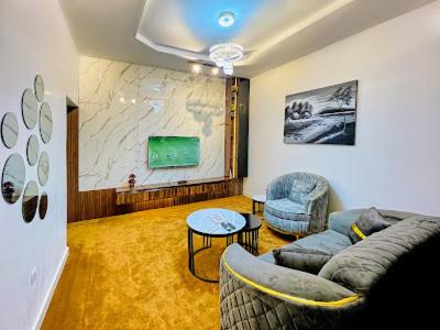 a living room with a couch and two chairs at Comfortable 1 bedroom Apartment in Garki