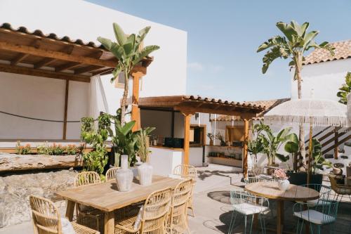 a patio with tables and chairs and a kitchen at Dreamsea Boutique Experience in Moya