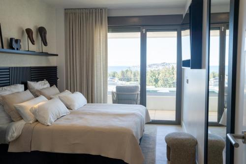 a bedroom with a large bed and a balcony at Beautiful Modern Town House - EDEN RESORT in Mijas Costa