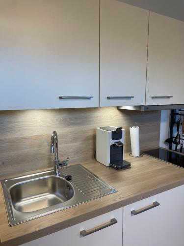 a kitchen counter with a sink and a coffee maker at Foxhome in Olching