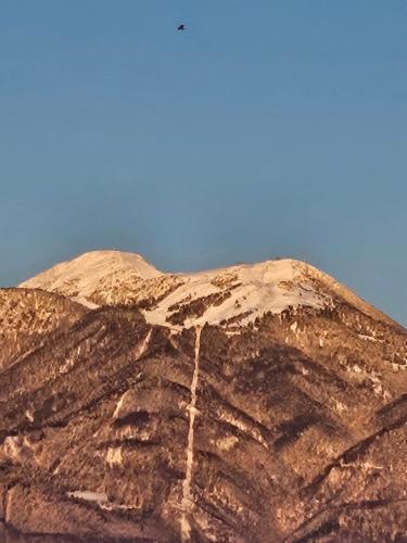 a brown mountain with the sky in the background at Apartma AJJA in Šenčur