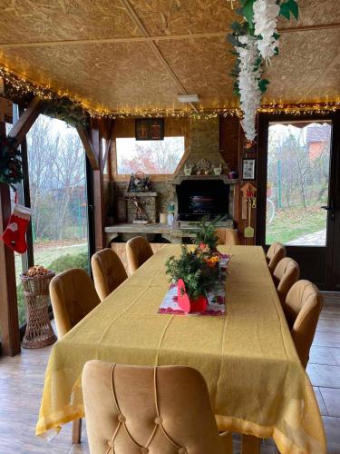 a dining room with a long table and chairs at Kuća Čerevićki Vidikovac in Čerević