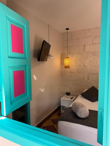 a room with two beds and a green door at CASA HOTEL LAS HORTENSIAS in Jardin