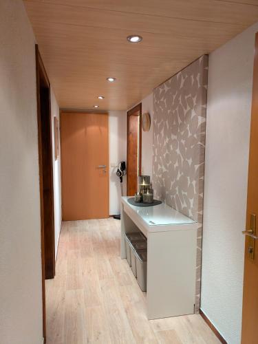 a room with a kitchen with a counter and a hallway at Haus Walch in Pettneu am Arlberg
