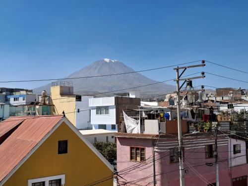 a view of a mountain from a city with buildings at Hotel Sideral AQP in Arequipa
