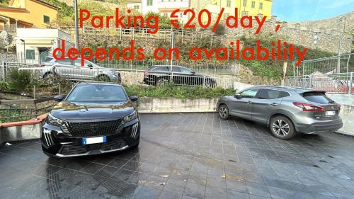 two cars parked next to each other in a parking lot at Ubetty village center two-bedrooms apartment 5terreparco in Riomaggiore