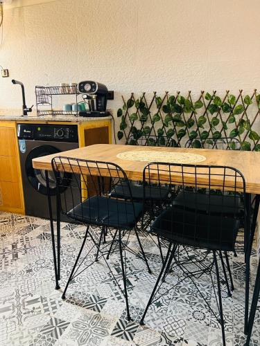 a table and chairs in a kitchen with a stove at Julie Airport Marrakech Apartments in Marrakech