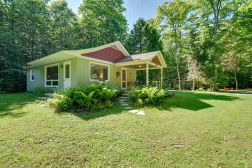 a small house with a red roof in a yard at Cherry Cottage - Walk to Peninsula State Park! in Ephraim