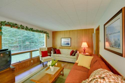 a living room with a couch and a tv at Cherry Cottage - Walk to Peninsula State Park! in Ephraim