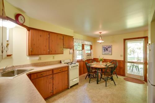 a kitchen with a table and a dining room at Cherry Cottage - Walk to Peninsula State Park! in Ephraim