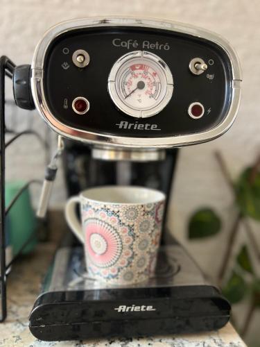 a coffee maker with a cup on a counter at Julie Airport Marrakech Apartments in Marrakech