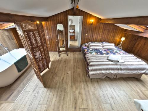 a large bedroom with a bed and a mirror at Villa Prestige, Tennis, Piscine & Spa, Sainte-Baume in Saint-Zacharie