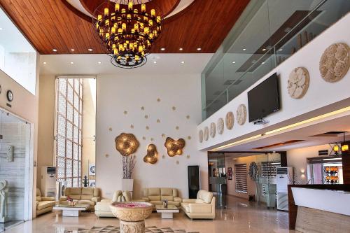 a lobby with couches and a television in a building at Club Mahindra Dwarka in Dwarka