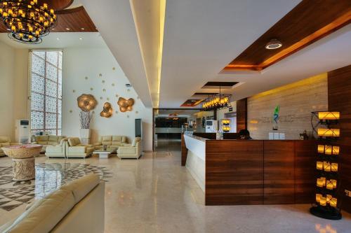 a lobby with couches and a bar in a building at Club Mahindra Dwarka in Dwarka
