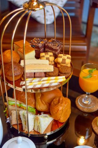 a plate of bread and pastries on a table at Tea Queens Bungalow in Hatton