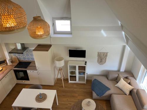 a living room with a couch and a table at Gemütliches Reetdachhaus in Oesterdeichstrich