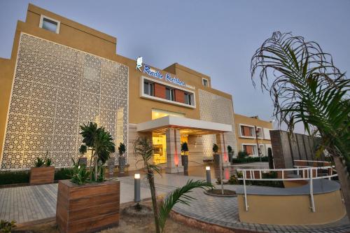 a building with a courtyard with trees and plants at Club Mahindra Dwarka in Dwarka