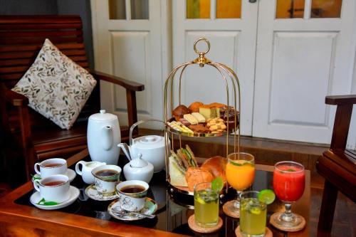 a tray of breakfast foods and drinks on a table at Tea Queens Bungalow in Hatton
