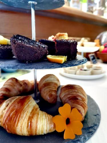 a plate of pastries and croissants on a table at Hotel Wandersleben - Erfurt in Wandersleben