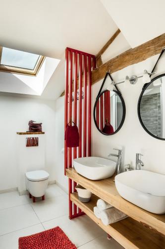 une salle de bain avec un lavabo et un miroir dans l'établissement Le grand gîte du monde de sophie, à Venansault