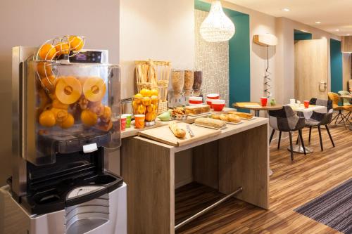 a kitchen with a bunch of food on a counter at ibis Styles Chaumont Centre Gare in Chaumont