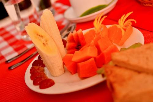 a plate of fruit and vegetables on a table at Tea Queens Bungalow in Hatton