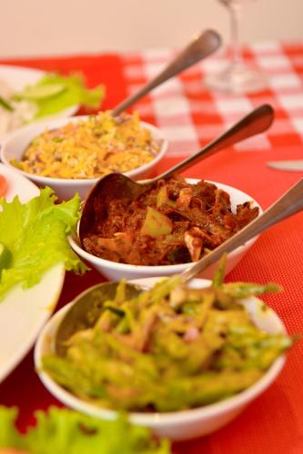 a table with three bowls of food on a table at Tea Queens Bungalow in Hatton