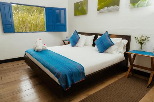 a bedroom with a bed with a stuffed animal on it at Reserva Guadalajara - Cocora Valley in Salento
