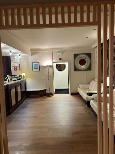 a living room with a couch and a kitchen at Hotel Taormina Brussels Airport in Zaventem