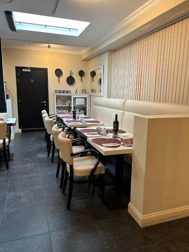 a long dining room with a long table and chairs at Hotel Taormina Brussels Airport in Zaventem