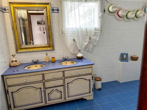 a bathroom with two sinks and a mirror at Villa Prestige, Tennis, Piscine & Spa, Sainte-Baume in Saint-Zacharie