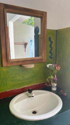 a bathroom with a sink with a mirror and a mirror at STARFISH beach bungalow in Arugam Bay