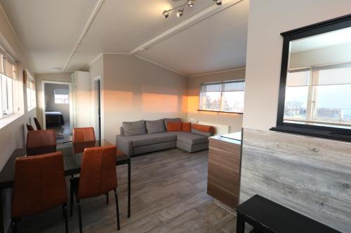 a living room with a couch and a table at Skýjaborg Apartments in Höfn
