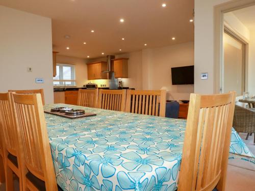 a dining room and kitchen with a table and chairs at Blue Horizon in Port Isaac