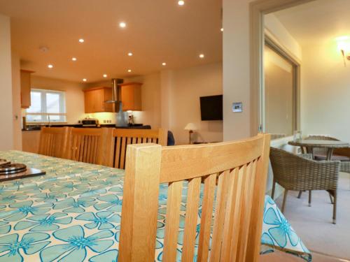 a dining room and kitchen with a table and chairs at Blue Horizon in Port Isaac