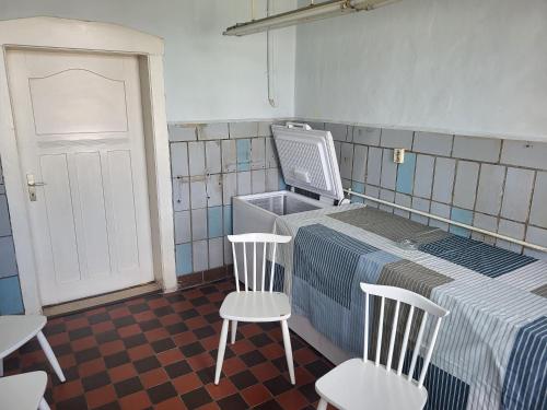 a room with a bed with two chairs and a tv at Wohnung im 1 OG mit Klima bis 6 Personen in Osterburg