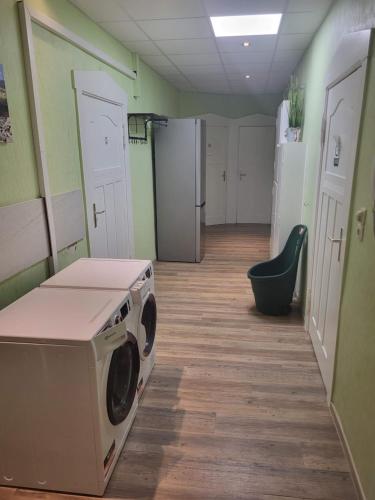 a laundry room with a washing machine in it at Wohnung im 1 OG mit Klima bis 6 Personen in Osterburg