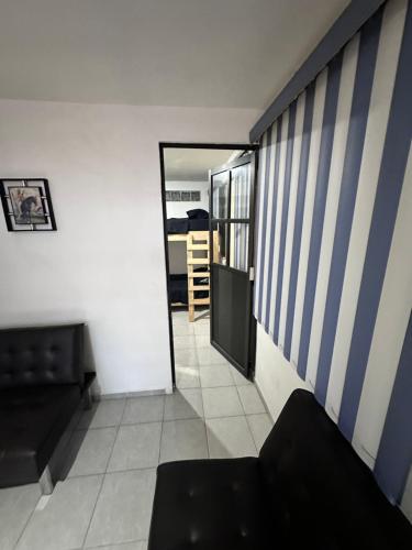 a living room with a couch and a hallway at Suite #4 Cerca de Auto. Mex-Qro. in Cuautitlán Izcalli