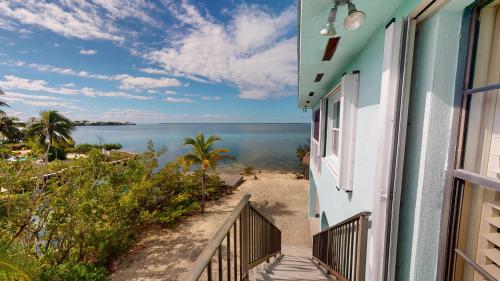 a balcony of a house with a view of the ocean at Sea La Vie in Cudjoe Key