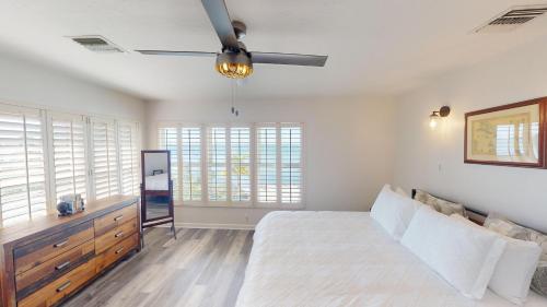a bedroom with a bed and a ceiling fan at Sea La Vie in Cudjoe Key