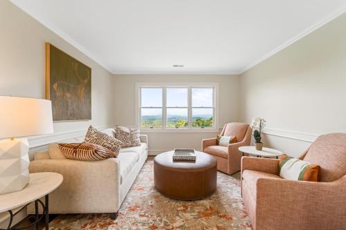 a living room with two couches and a table at Inn at Brierley Hill in Lexington