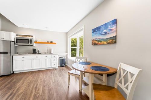 a kitchen with a wooden table and a dining room at Inn at Brierley Hill in Lexington