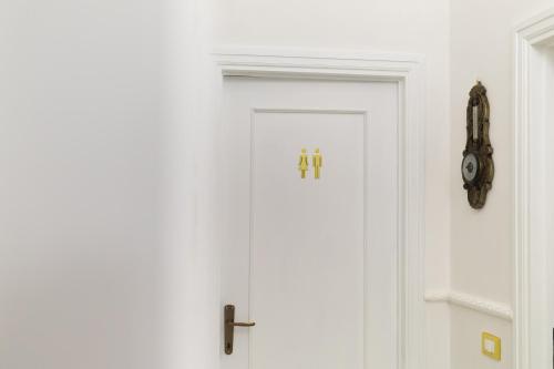 a white door with a cross on it at San Massimo Apartment - Piazza Duomo L'Aquila in LʼAquila